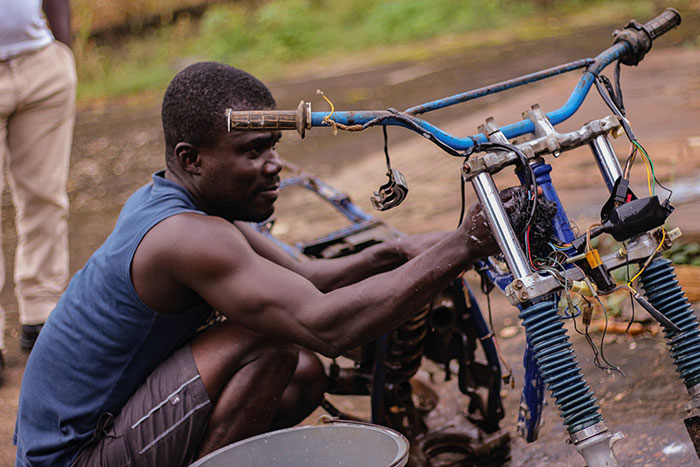 Person fixing a bike outdoors, enjoying some "me time," focused on repairs and maintenance.