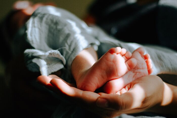 person holding baby's feet