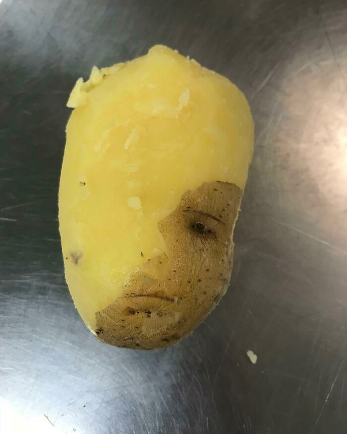 A potato resembling a face on a metal surface, showcasing an interesting image from Cultureavenue.