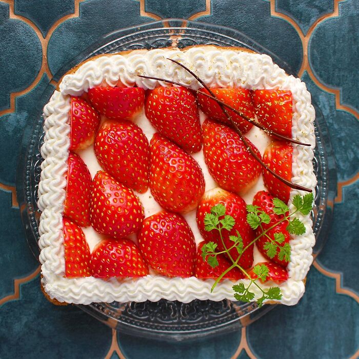 Creative toast design with strawberries and whipped cream by Japanese artist.
