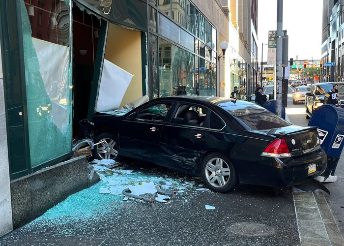 Car crash through a glass building facade, illustrating a harrowing situation turned safe by intuition.