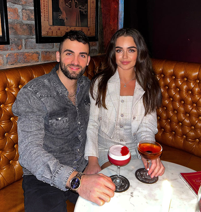 Couple enjoying drinks at a bar, featuring 25 year-old pro boxer Georgia O’Connor in a casual setting.