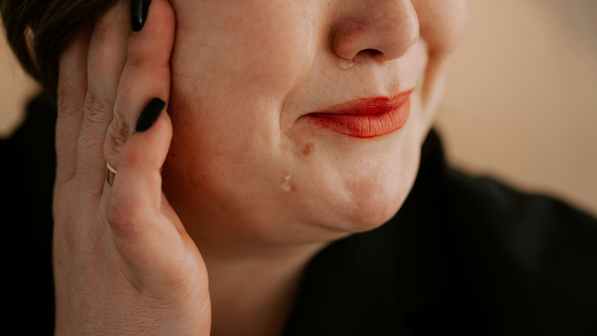 Close-up of a woman with red lipstick and black nails, illustrating themes of obesity and fat shaming in family care.