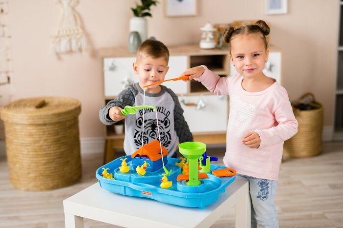 Two children playing with a blue fishing game toy, illustrating people who called off their wedding breaking down why.